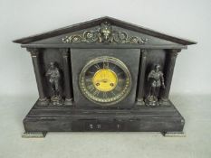 A late 19th century French black marble mantel clock,