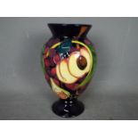 Moorcroft - a ceramic Queens Choice vase,