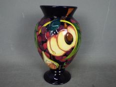 Moorcroft - a ceramic Queens Choice vase,