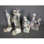 A collection of Spanish Porcelain figurines, predominantly by Nao, largest approximately 29 cm (h).