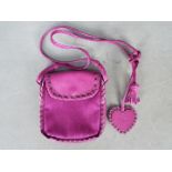 A monogram (Dior) cross body bag, fuchsia pink with leather embossed tag marked Dior,