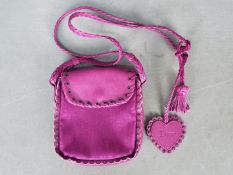 A monogram (Dior) cross body bag, fuchsia pink with leather embossed tag marked Dior,