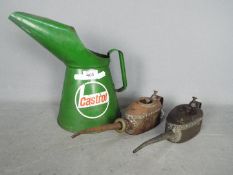 Two vintage Kaye's oil cans and a two litre Castrol oil can.