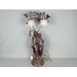 A large, twin light, figural table lamp with pink glass shades, approximately 77 cm (h).