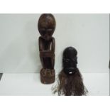 Two wooden Tribal carvings. Tallest is 7