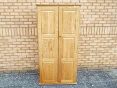 A pine twin door wardrobe measuring appr