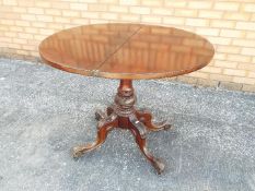 A Victorian flip top round table suppor
