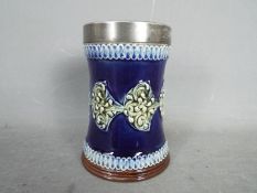 A Doulton ceramic vase decorated with me