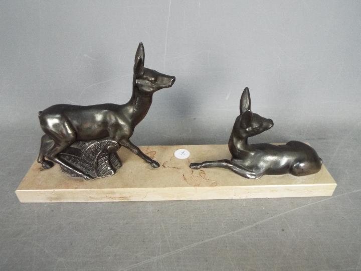 A deer set on a marble plinth, approx 16