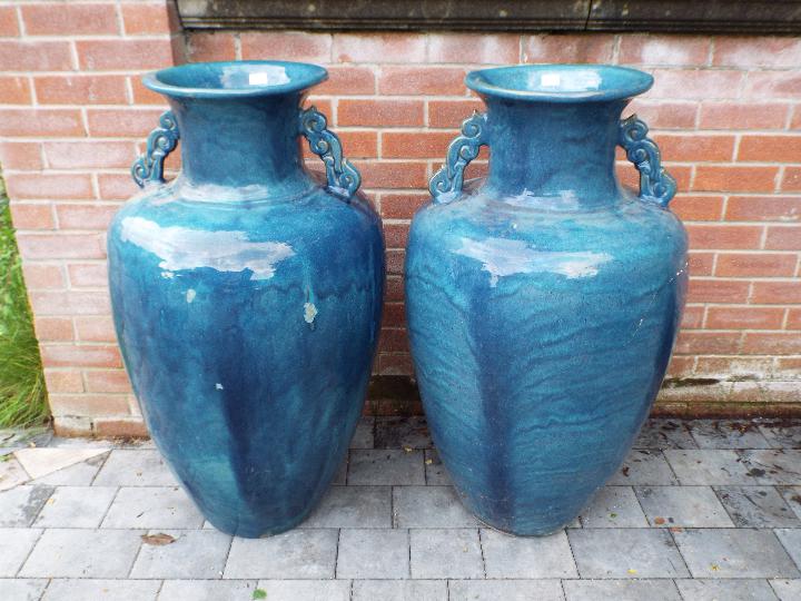 Garden décor - a pair of large blue twin handled urns,