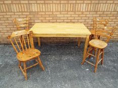 A modern dining table 76 cm x 140 cm x 80 cm with three pine breakfast stool and one pine dining