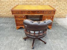 A pedestal desk, the kneehole flanked by columns having three drawers,