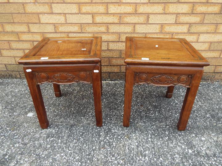 A pair of lamp tables with carved detailing and brass inlay, approximately 49 cm x 41 cm x 41 cm.