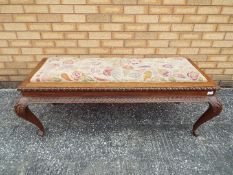 An upholstered bench seat with carved detailing, approximately 48 cm x 130 cm x 55 cm.