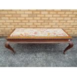 An upholstered bench seat with carved detailing, approximately 48 cm x 130 cm x 55 cm.