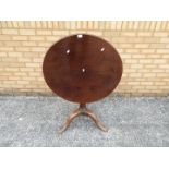 A circular tilt top, mahogany table, approximately 71 cm x 74 cm.