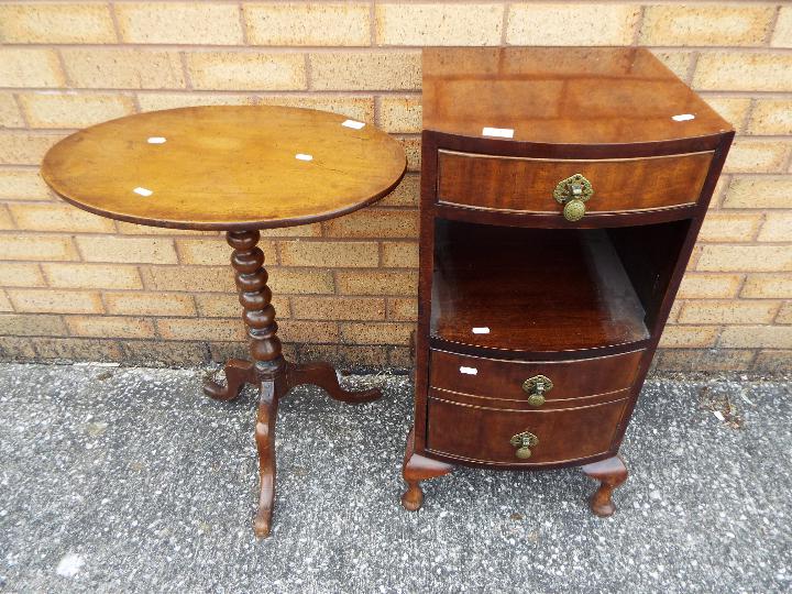 A small oval tilt top table on bobbin turned column and tripod supports,