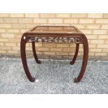 A Chinese side table with decoration of carved prunus, approximately 60 cm x 67 cm x 41 cm.