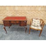 A leather topped mahogany desk on cabriole supports,