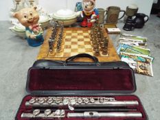 A metal chess set with board, a cased Yamaha flute, a pair of fireside dogs, three Meakin tureens,