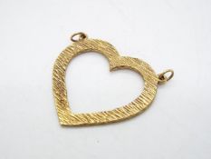 A 9ct gold heart shaped pendant with textured surface, approximately 4.1 grams all in.