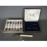 A set of six Sterling silver tea spoons with inlaid finials,