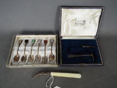 A set of six Sterling silver tea spoons with inlaid finials,