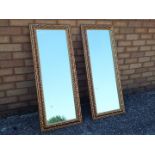 A matched pair of rectangular gilt framed mirrors,