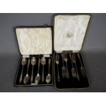 Two cased sets of hallmarked silver cutlery comprising a George VI set of six coffee spoons,