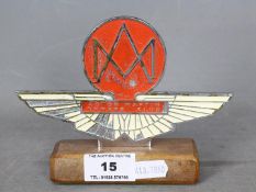 Automobilia - Aston Martin Owners Club car badge on wooden base, approximately 11 cm (h).