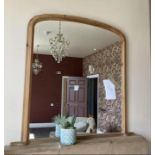 A pine framed over mantel mirror,