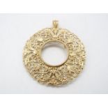 A 9ct gold sovereign pendant with scrolling openwork decoration, 5 cm (d), approximately 12.