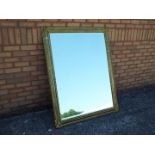 A large gilt framed, bevel edged, mirror,