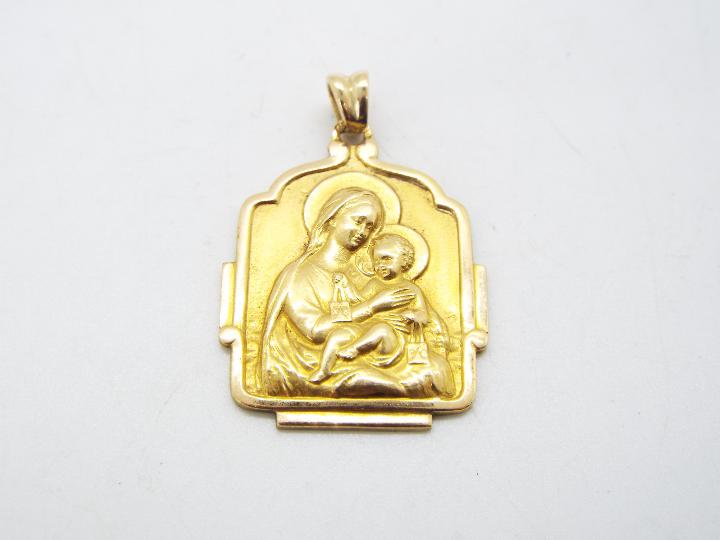 A yellow metal religious pendant (markings unclear but presumed 9ct) with depiction of the Madonna