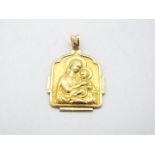 A yellow metal religious pendant (markings unclear but presumed 9ct) with depiction of the Madonna