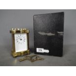 A French 8 day carriage clock in serpentine front, lacquered brass case,