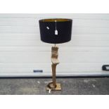 A good quality floor standing lamp with gold tone, bark effect finish and black shade,