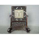 A carved wood and jade table screen,