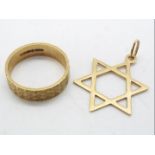 A 9ct gold wedding band, size K and a 9ct gold Star of David pendant, approximately 3.