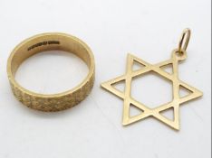 A 9ct gold wedding band, size K and a 9ct gold Star of David pendant, approximately 3.