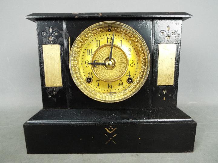 A cast iron cased mantel clock by Ansonia, USA,