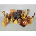 A quantity of treen, animal carvings, religious carvings and similar.