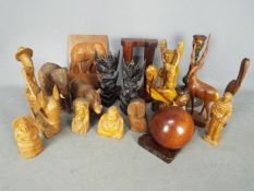 A quantity of treen, animal carvings, religious carvings and similar.