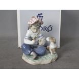 Lladro - A boxed figural group entitled I Hope She Does, # 5450, approximately 14 cm (h).