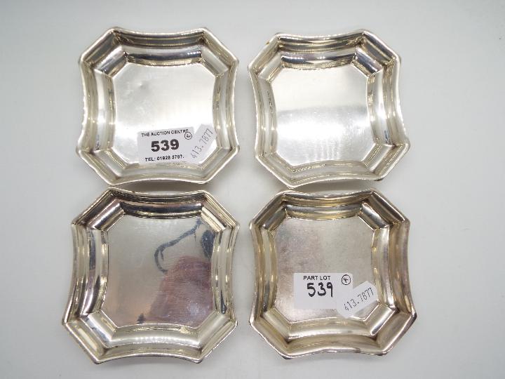 A set of four hallmarked silver, shallow dishes of shaped form, Birmingham assay,