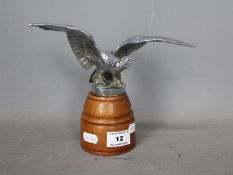 Automobilia - A car mascot in the form of an eagle with outstretched wings, mounted on wooden base,