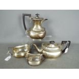 A George V hallmarked silver tea service comprising teapot, hot water jug, sugar bowl and cream jug,