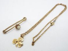 A 9ct yellow gold Shamrock pendant on yellow metal chain (presumed 9ct) and a yellow metal,