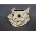 A Bretby Pottery grotesque cat head vase with applied glass eyes, approximately 12 cm (h).