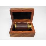 A brass and leather bound mini telescope,